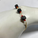 14 Karat Yellow Gold Curb Link Bracelet with (3) 6mm Azabache Jet and Coral Beads