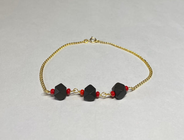 14 Karat Yellow Gold Curb Link Bracelet with (3) 6mm Azabache Jet and Coral Beads