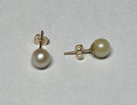 Genuine 6mm White Round Freshwater Pearl Stud Earrings set in 14 Karat Yellow Gold