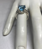 Sterling Silver and Genuine 12 x 10mm Oval Sky Blue Topaz Scroll Design Ladies Solitaire Ring