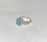 Sterling Silver and Genuine 12 x 10mm Oval Sky Blue Topaz Scroll Design Ladies Solitaire Ring