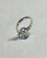 Sterling Silver and Genuine 12 x 10mm Oval Sky Blue Topaz Scroll Design Ladies Solitaire Ring