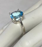 Sterling Silver and Genuine 12 x 10mm Oval Sky Blue Topaz Scroll Design Ladies Solitaire Ring