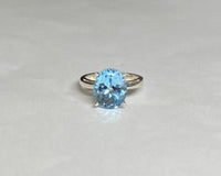 Sterling Silver and Genuine 12 x 10mm Oval Sky Blue Topaz Scroll Design Ladies Solitaire Ring