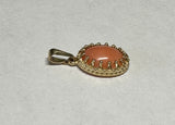 14 Karat Yellow Gold Genuine 10 x 8mm Oval Cabochon Pink Coral Pendant in Crown Style Setting