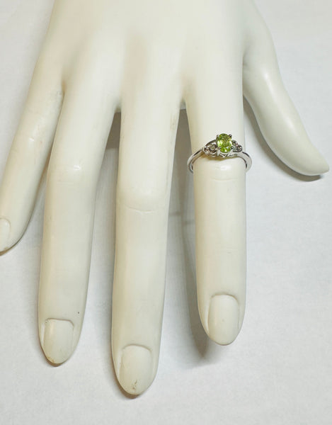 Sterling Silver Rhodium-plated Genuine Oval 6mm x 4mm Peridot Ladies Ring with Hearts