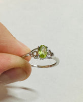 Sterling Silver Rhodium-plated Genuine Oval 6mm x 4mm Peridot Ladies Ring with Hearts